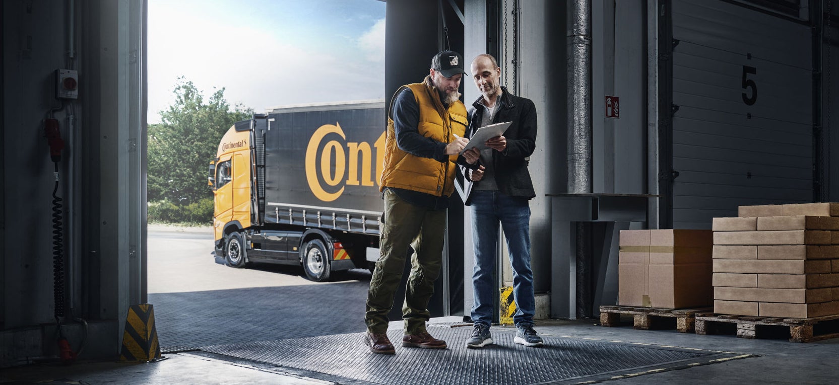 three people walking infront of trucks