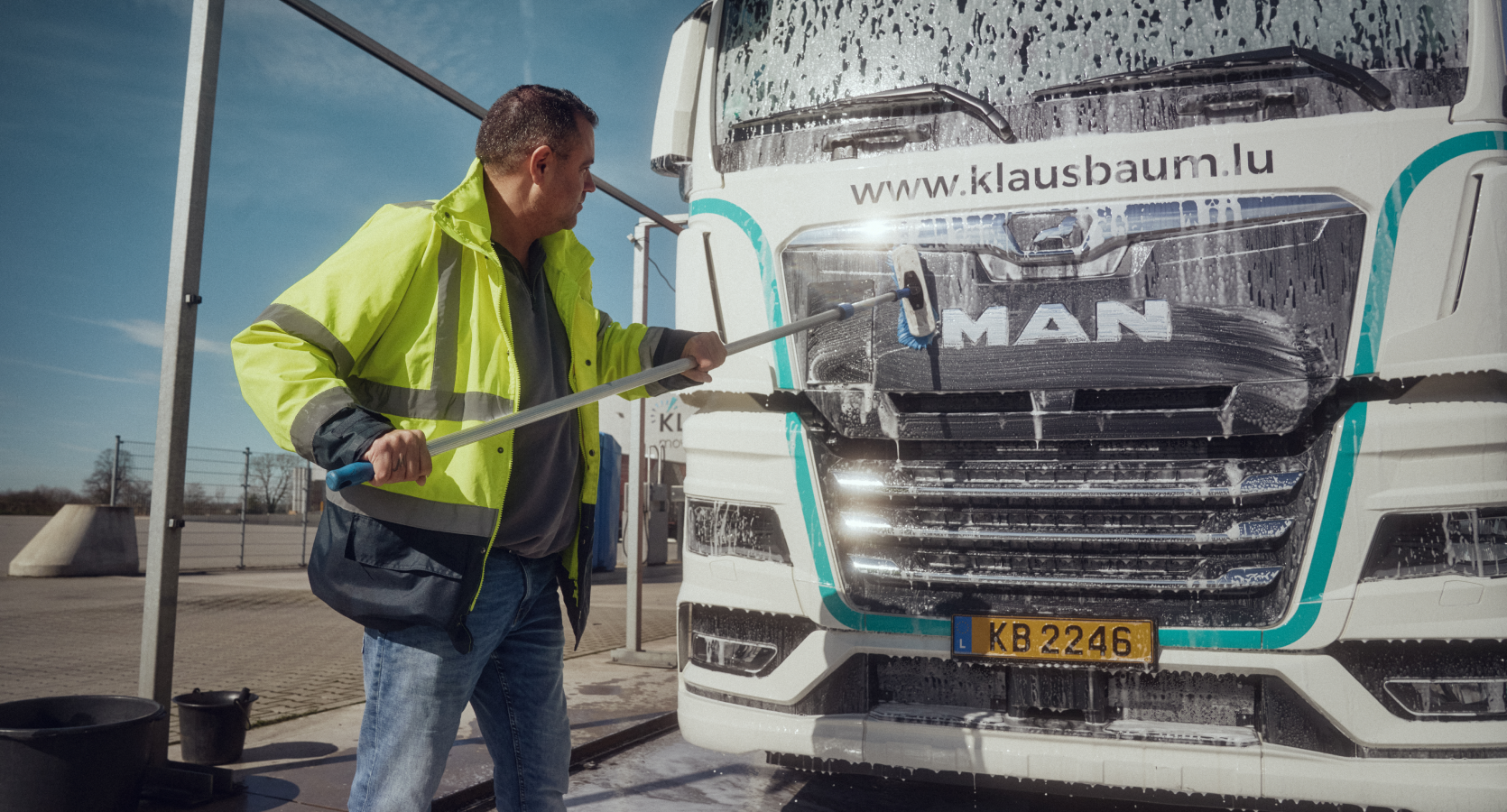 A worker cleans a truck