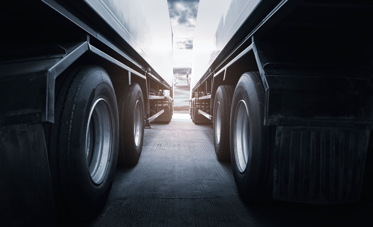 Semi Trailer Trucks the Parking at Sunset Sky. Truck Wheels Tires. Industry Cargo Freight Truck Transportation.; Shutterstock ID 1925982782; purchase_order: -; job: -; client: -; other: -